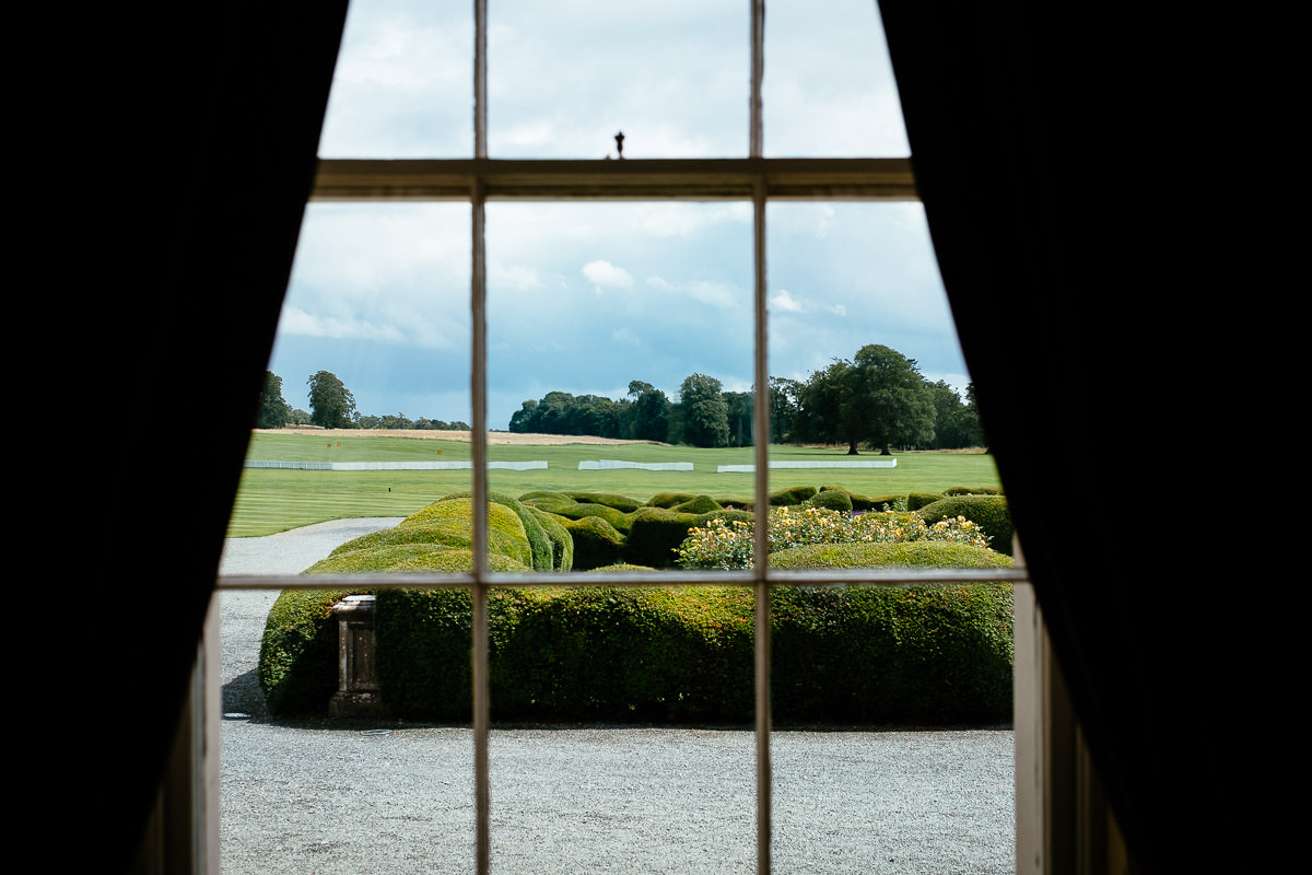 View through a bedroom window overlooking the grounds and golf course at Carton House.