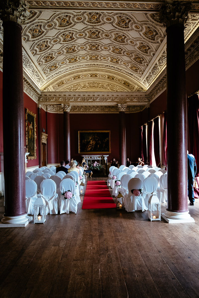 Rows of white chair covers set up for the ceremony in one of the grand rooms at Carton House.