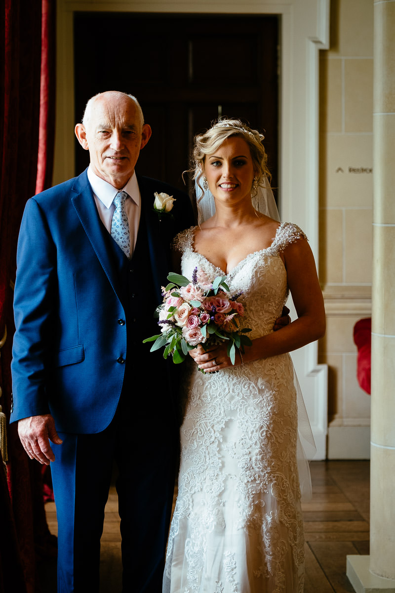 The bride poses with her father before walking down the aisle at Carton House.