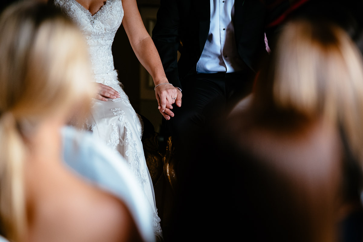 Close-up of the bride and groom holding hands during their ceremony at Carton House.