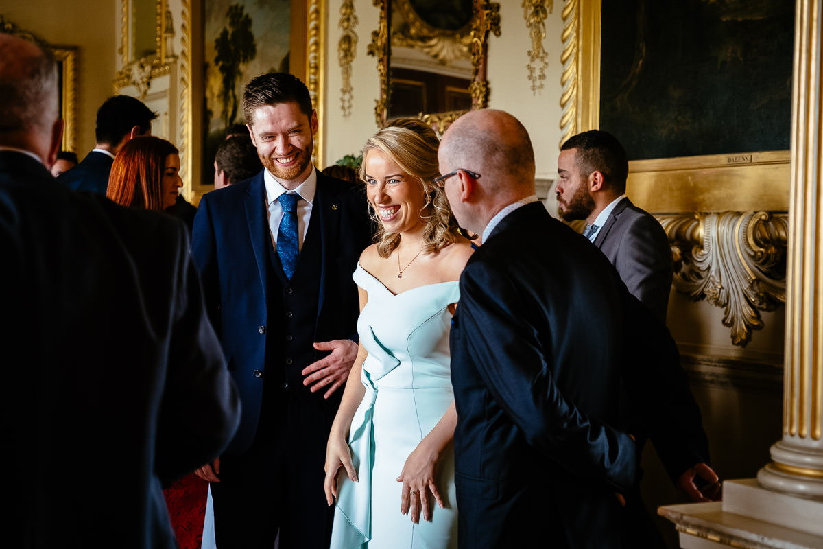 The bride laughs with guests during the drinks reception at Carton House.