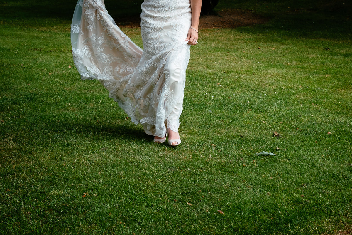 Close-up of the bride's dress and shoes as she walks across the lawn at Carton House.