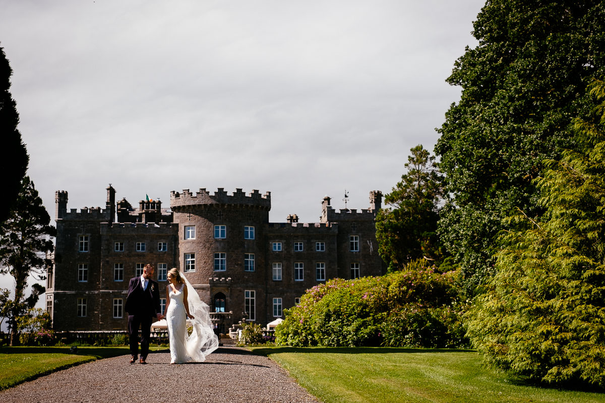 bride and groom walking through the gardens at their markree castle wedding