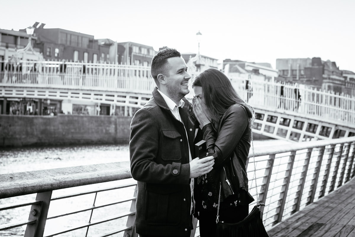 couple proposing by the river liffey boardwalk in dublin