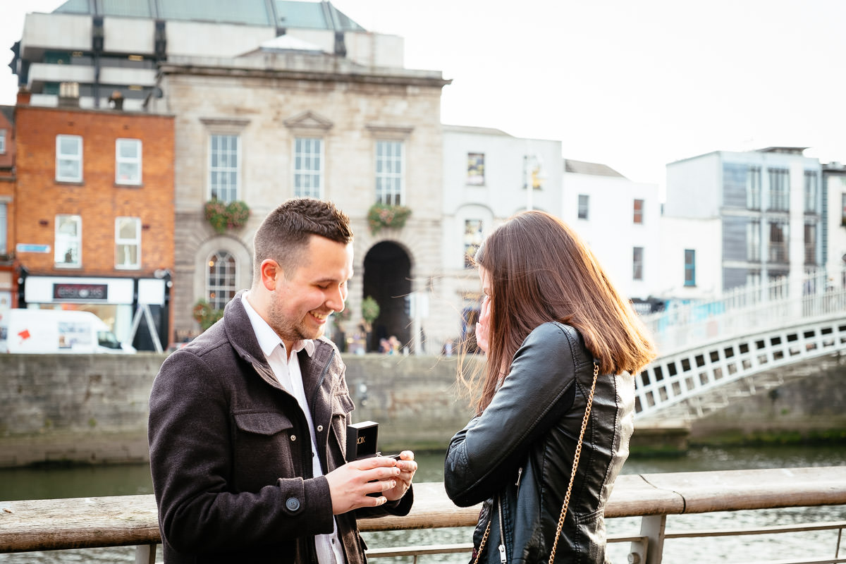 couple proposing by the river liffey boardwalk in dublin