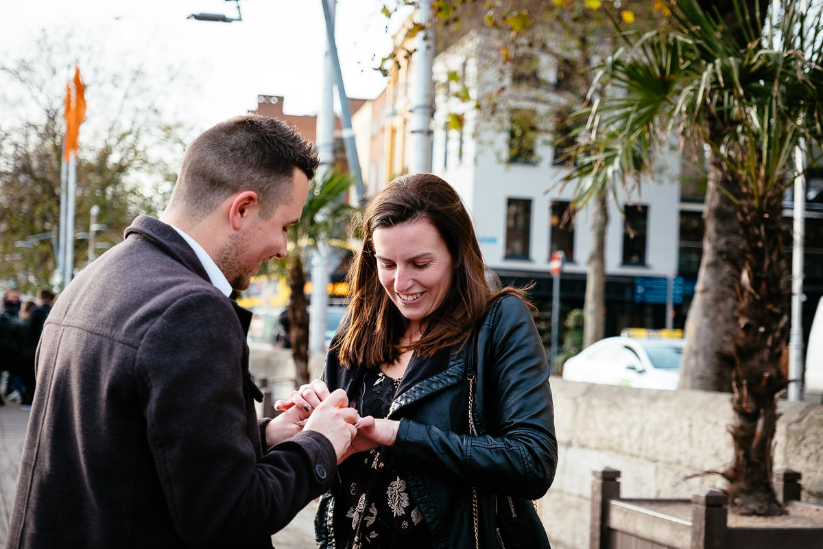 couple proposing by the river liffey boardwalk in dublin