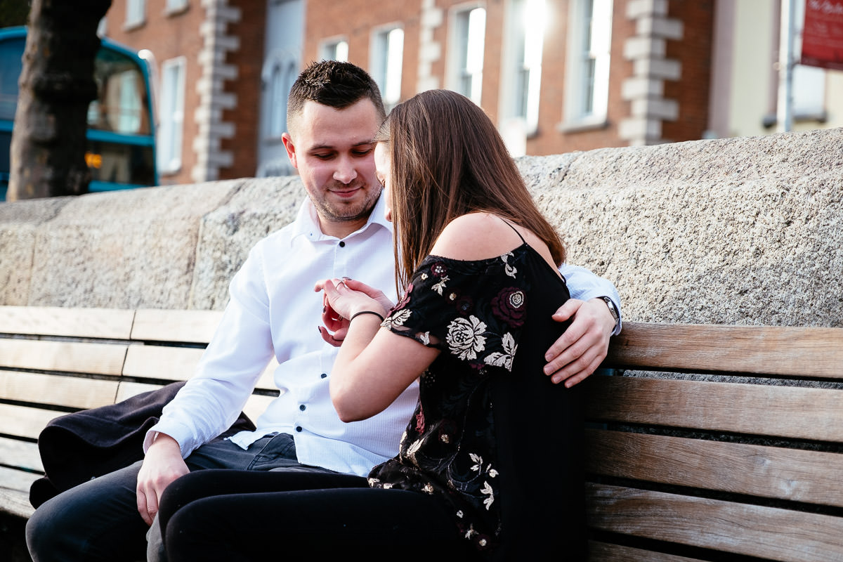 couple who just proposed by the river liffey boardwalk in dublin