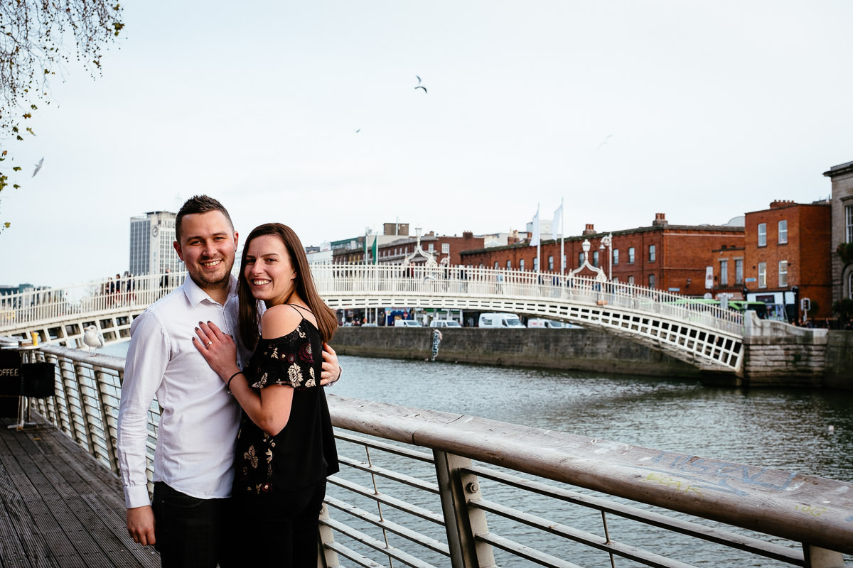 newly engaged couple by the river liffey boardwalk in dublin