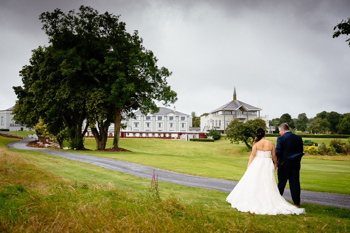 bride and groom walking at gleno abbey hotel wedding