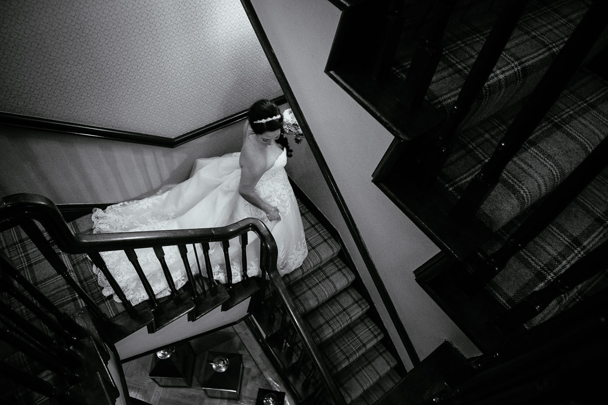 bride walking down stairs at gleno abbey hotel wedding