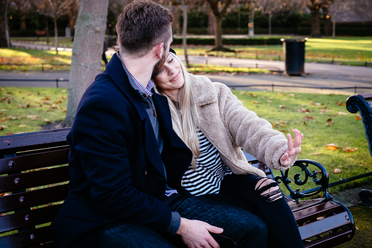 engaged couple admiring her ring in st stephens green dublin