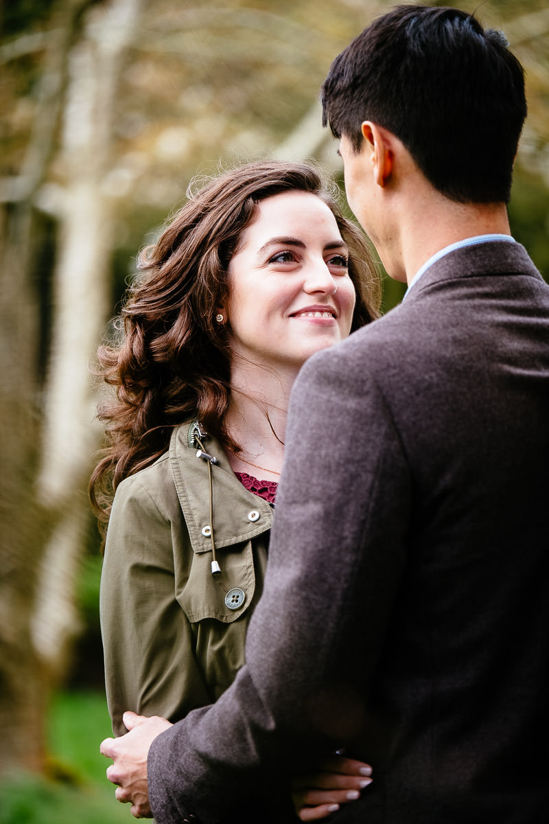 engaged couple laughing in dublin park