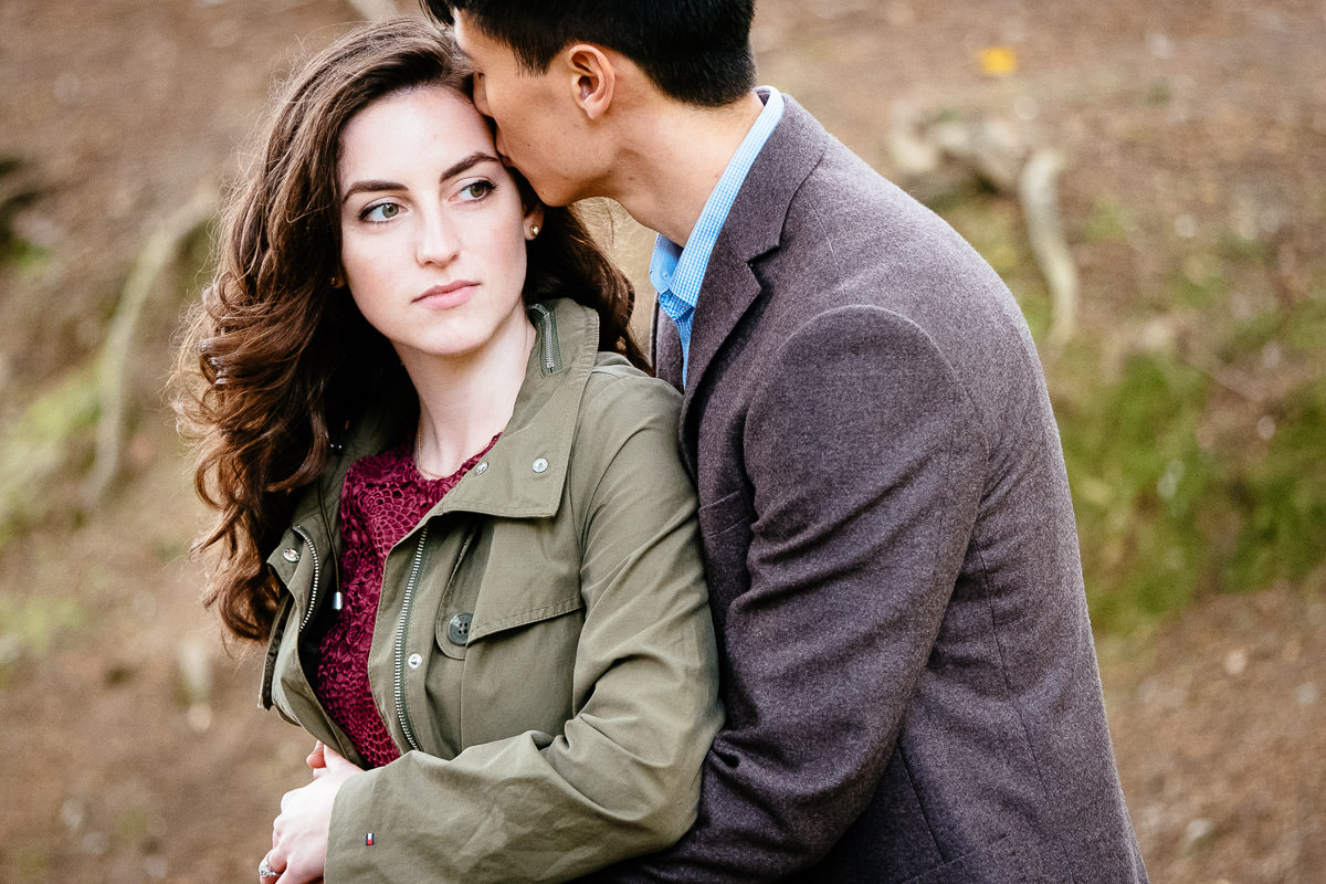 engaged couple kissing in st annes park