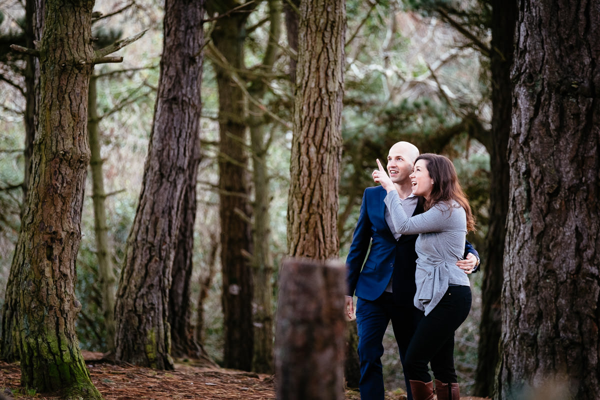 engaged couple in forest at sun set