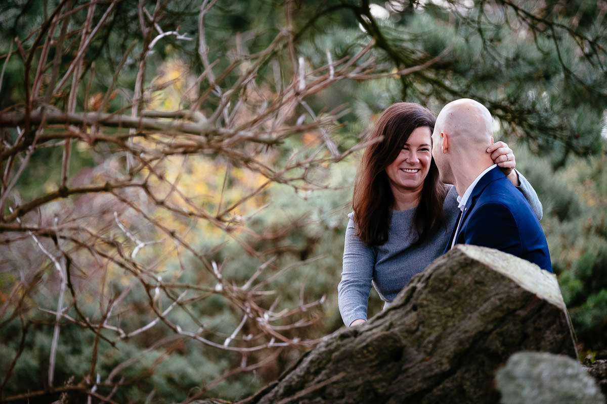 engaged couple in forest at sun set