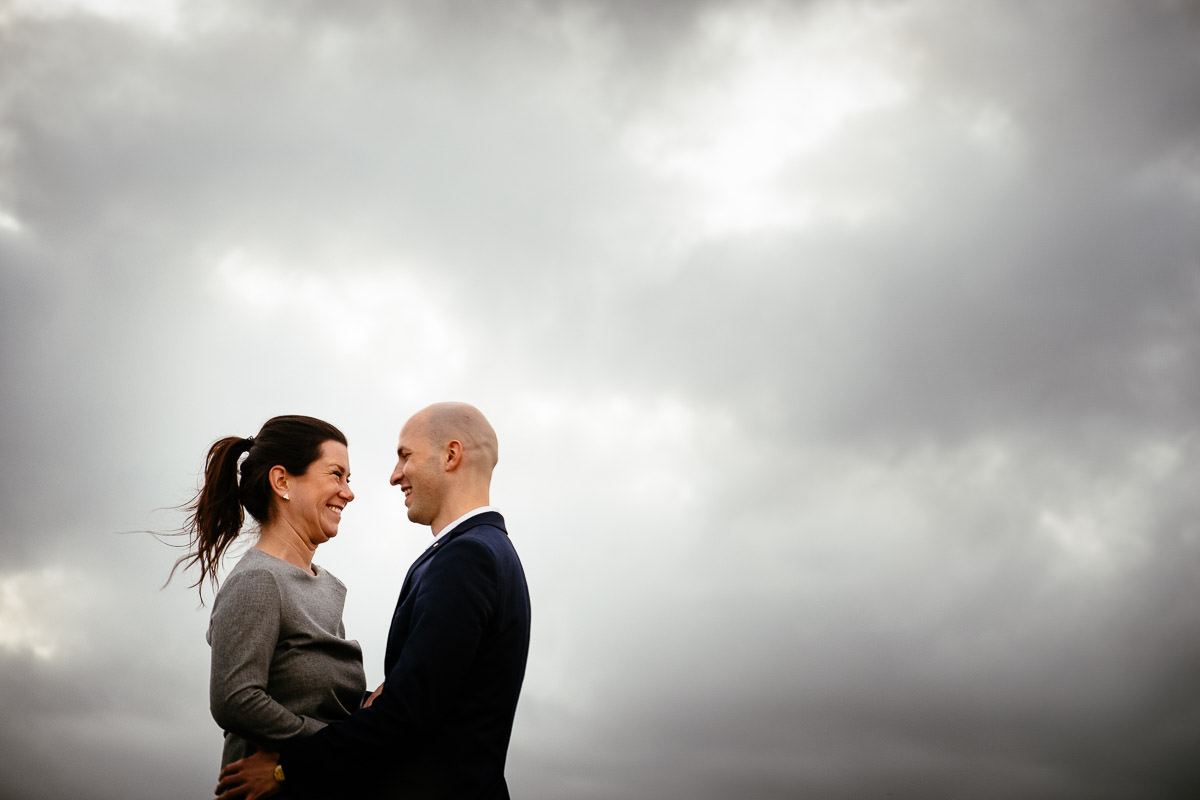 engaged couple with sky in the background