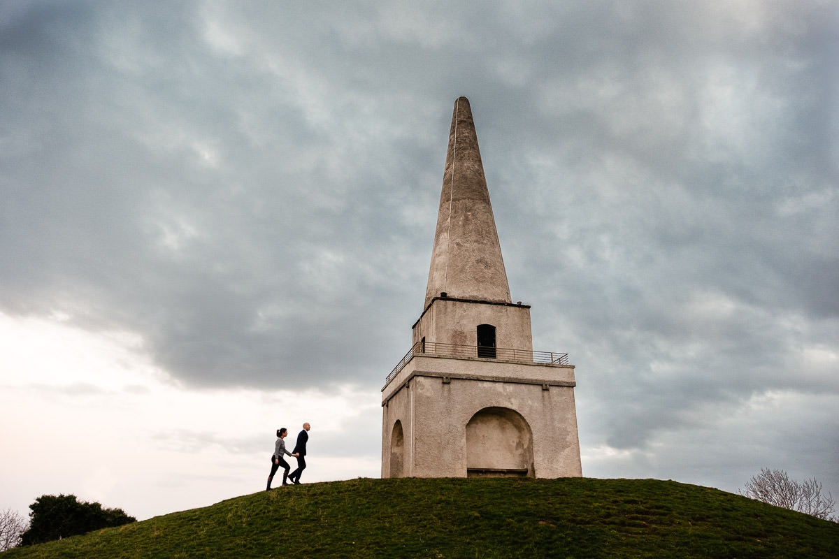 engaged couple walking up killiney hill