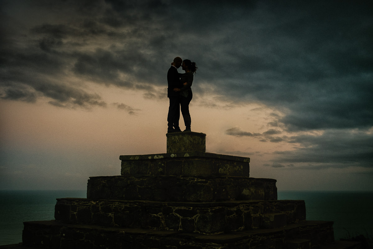engaged couple with sunset in the background