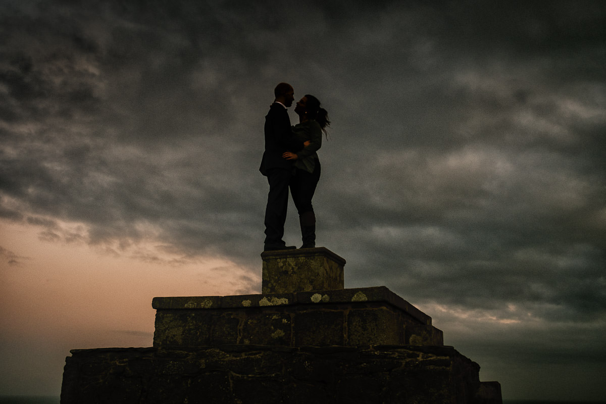 engaged couple with sky in the background