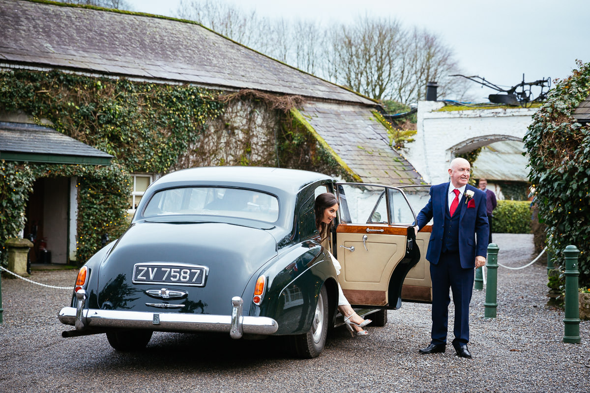 Winter Wedding in Rathsallagh House Wicklow 37 bride and groom in wedding car arriving at rathsallagh house