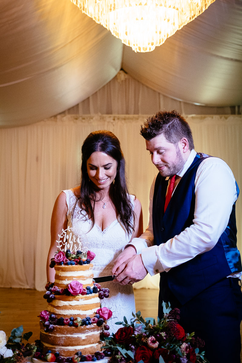 Winter Wedding in Rathsallagh House Wicklow 70 bride and groom cutting wedding cake at rathsallagh house wicklow