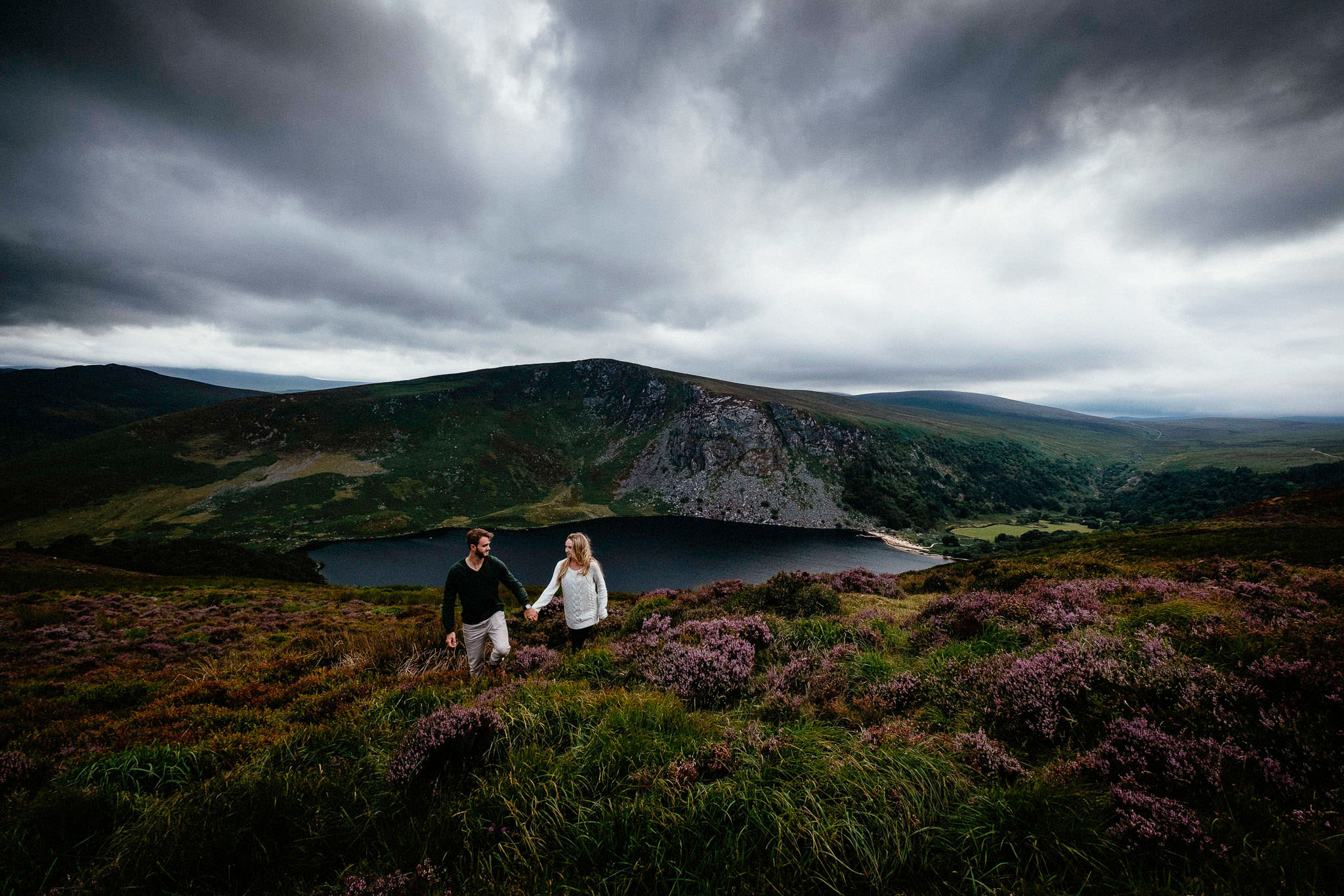 engaged couple walking through heather in rural ireland