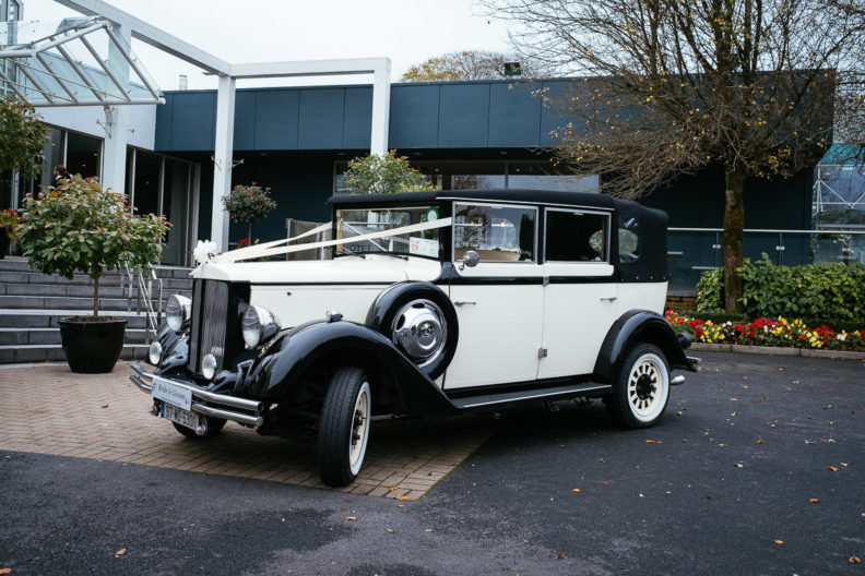 vintage wedding car parked outside hotel