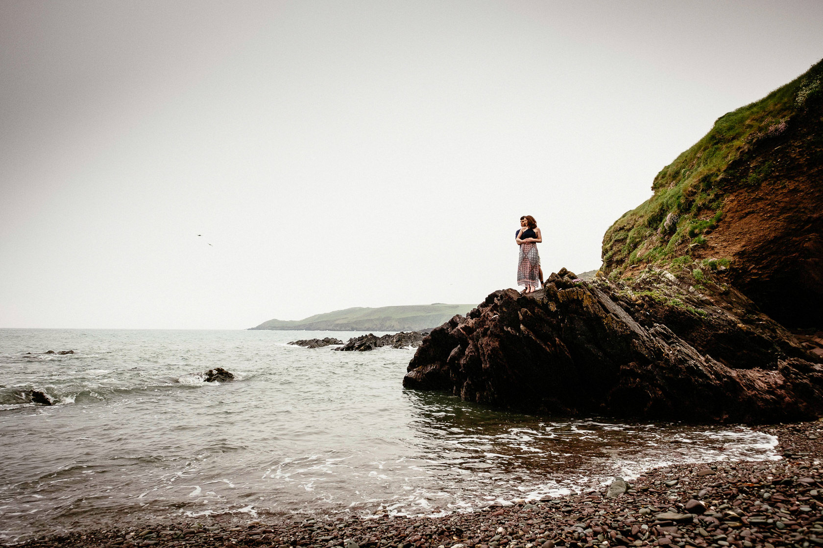 engaged couple embracing on a cliff in ballycotton county cork ireland