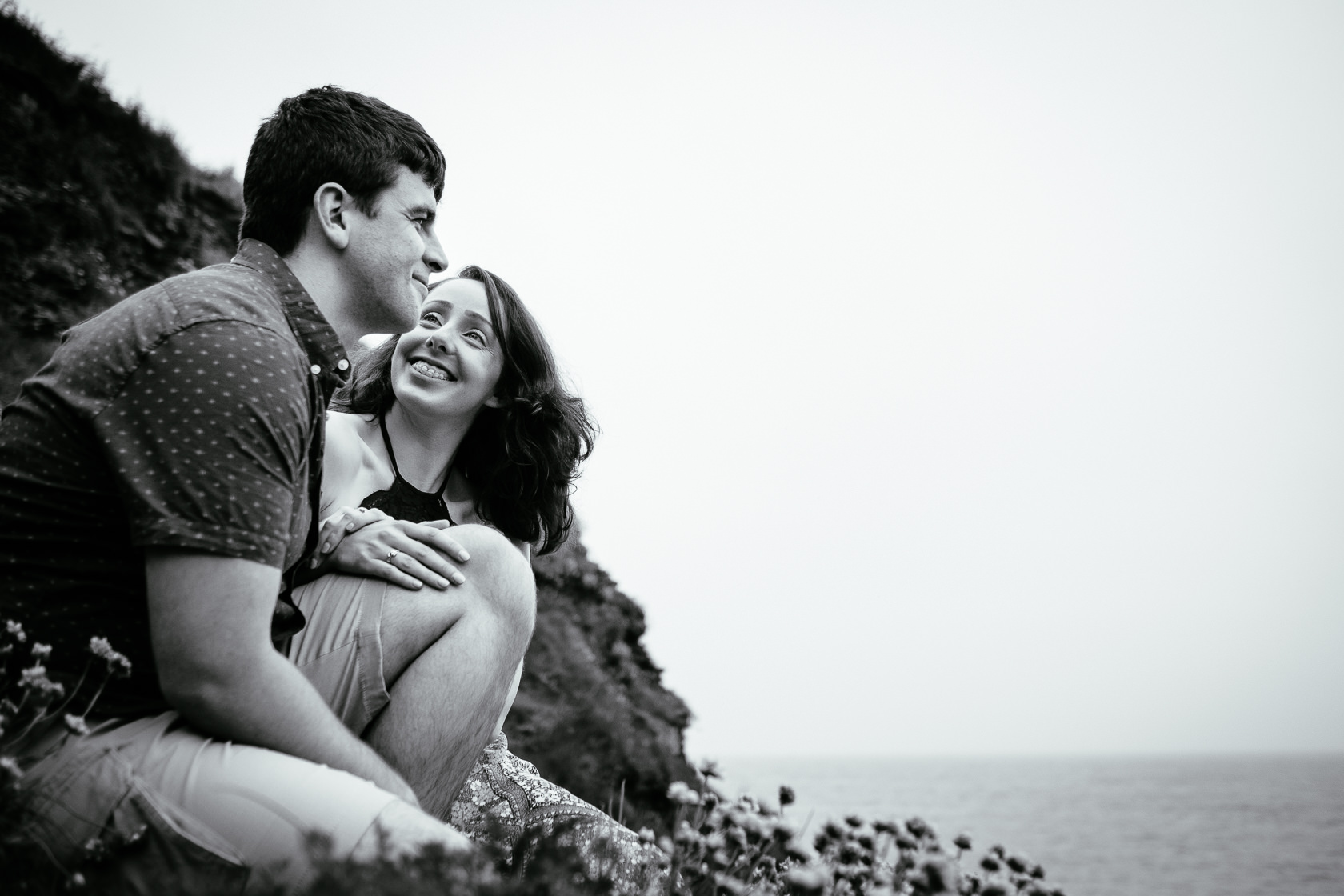 engaged couple talking on a cliff in ballycotton county cork ireland