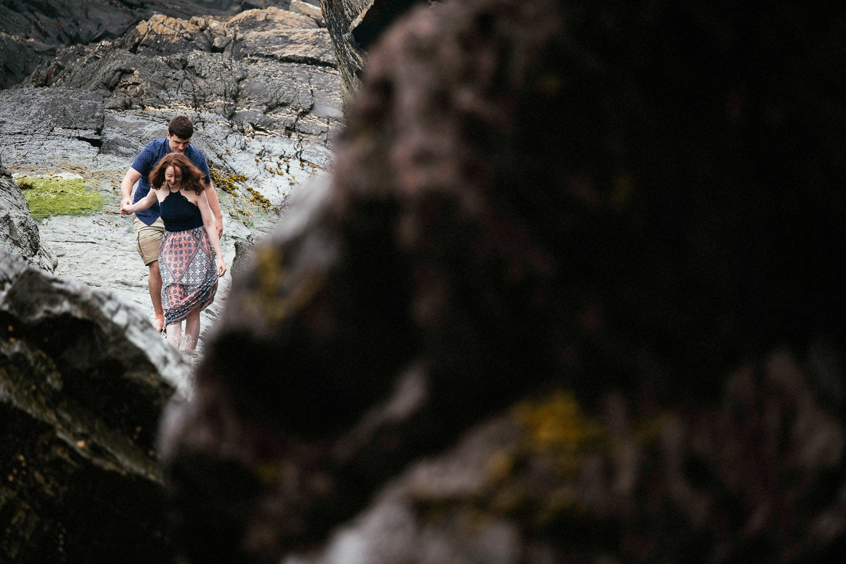engaged couple walking in the sea off the coast of county cork ireland