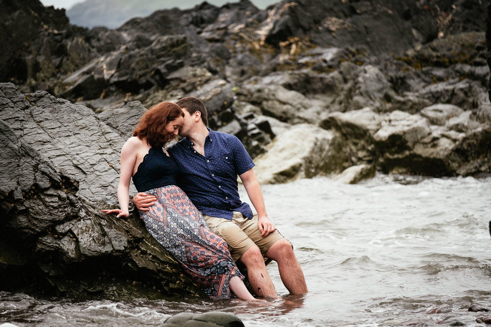 engaged couple standing in the sea off the coast of county cork ireland