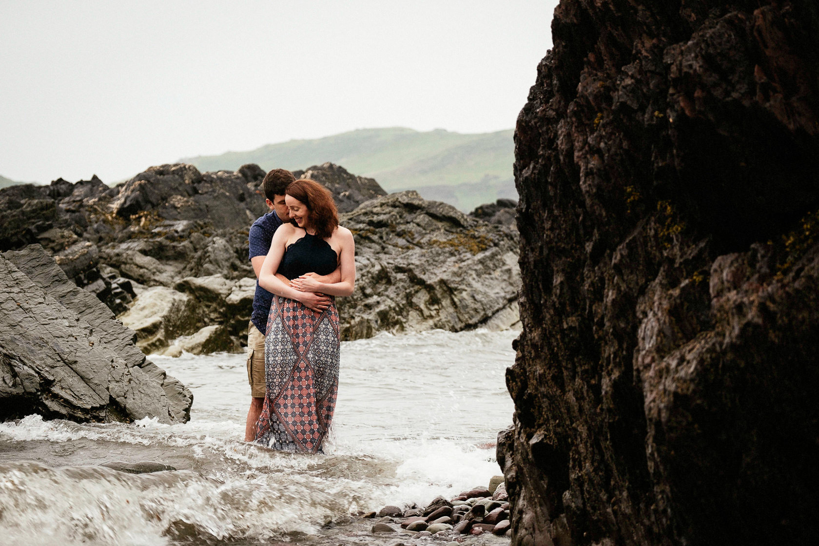 engaged couple standing in the sea off the coast of county cork ireland