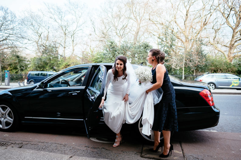 bride getting out of car at church