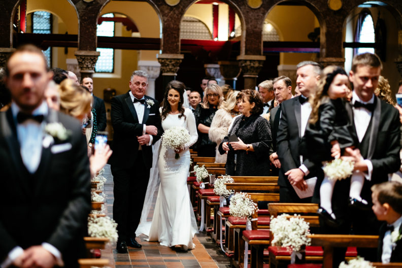 bride and her father walking up aisle