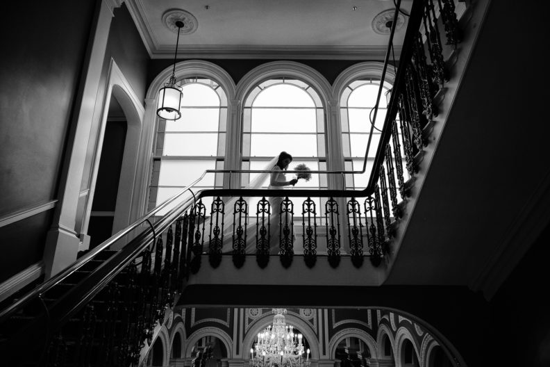 silhouette of a bride walking across landing of hotel