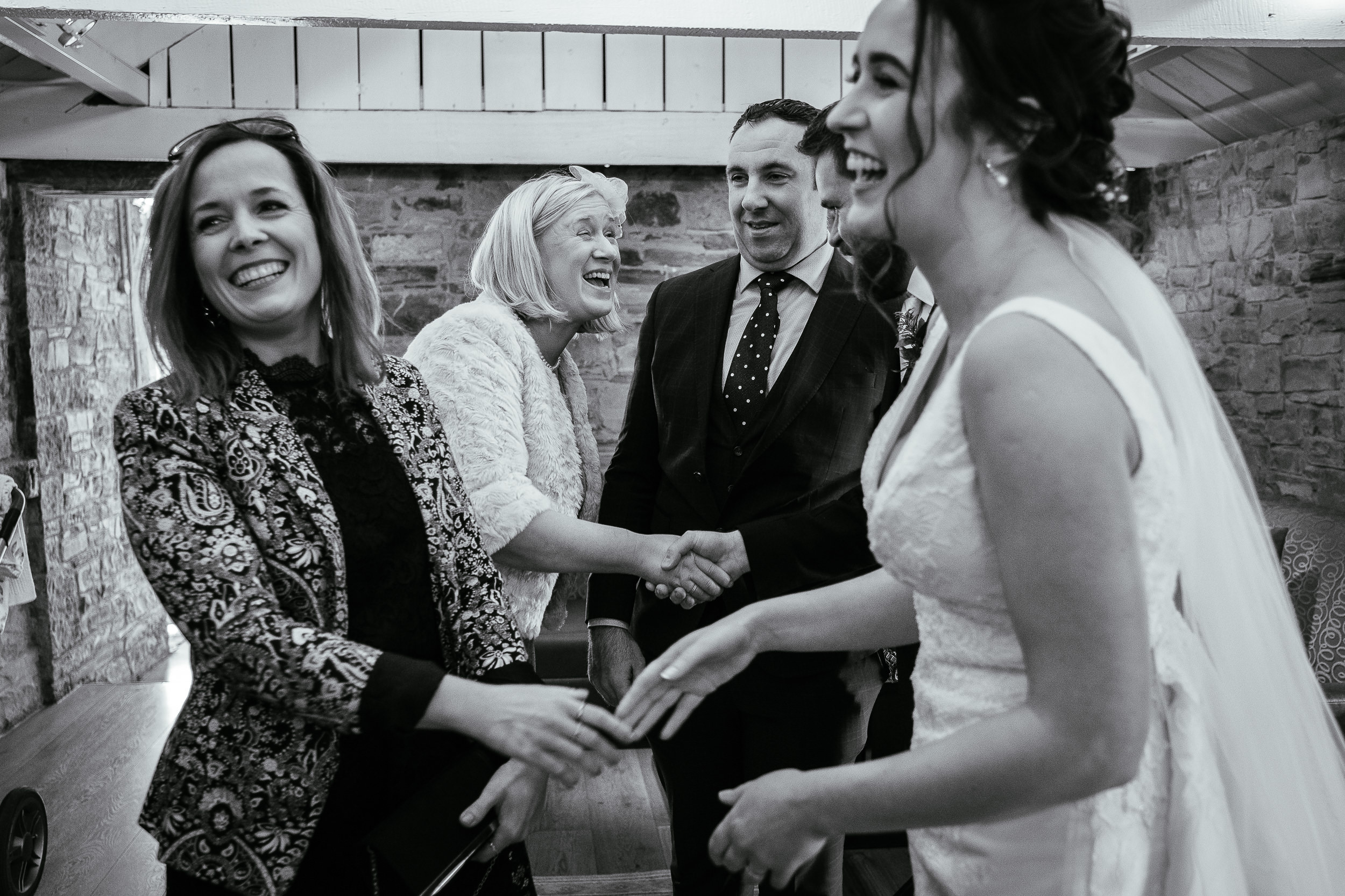 bride and groom being congratulated by guests