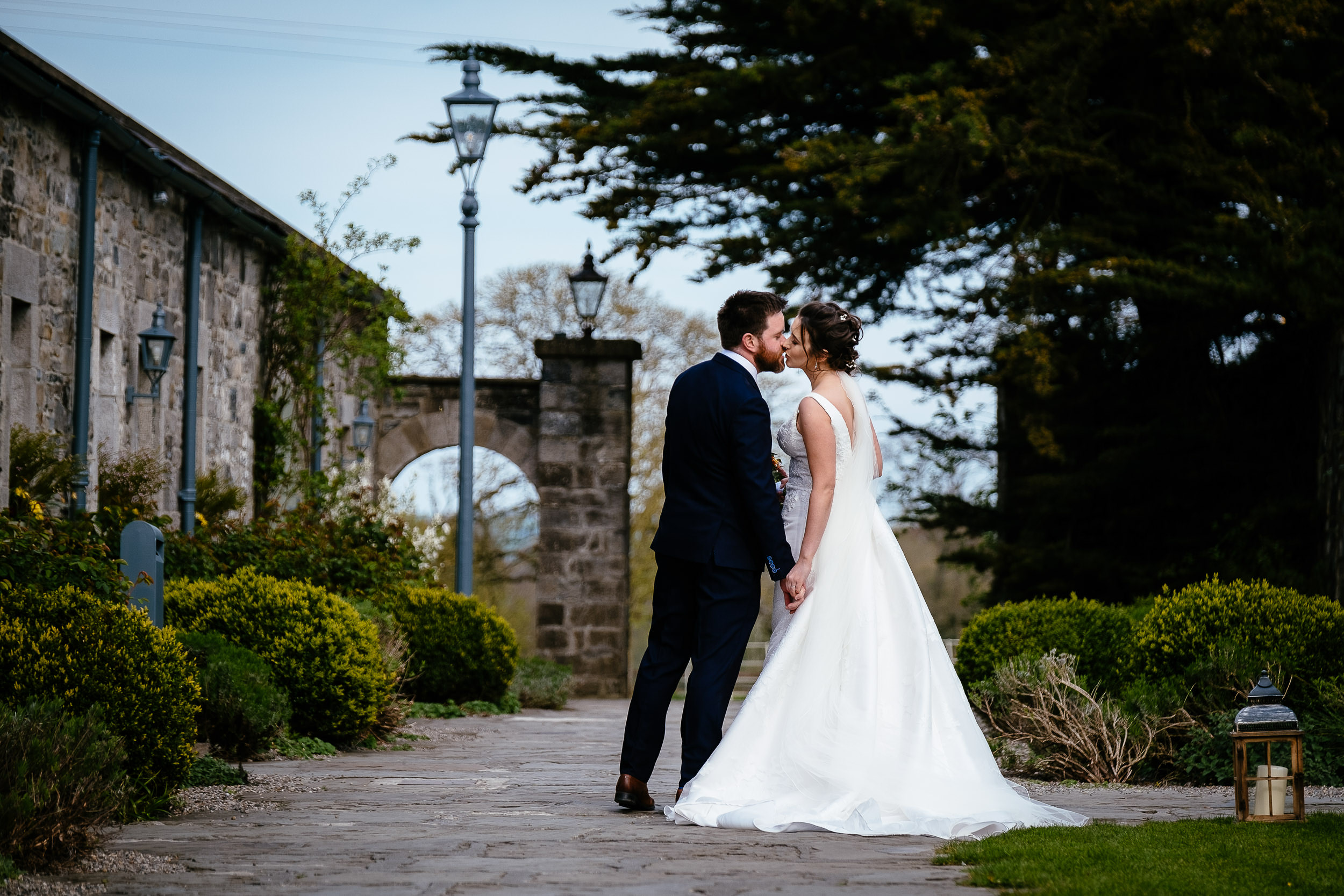 bride and groom kissing in courtyard