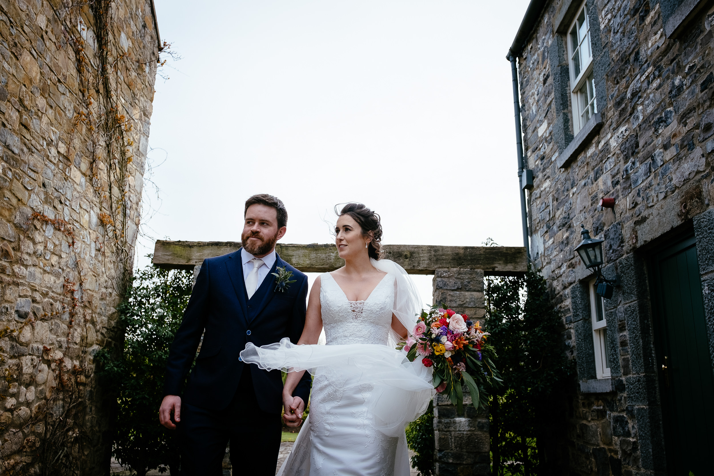 bride and groom walking towards camera