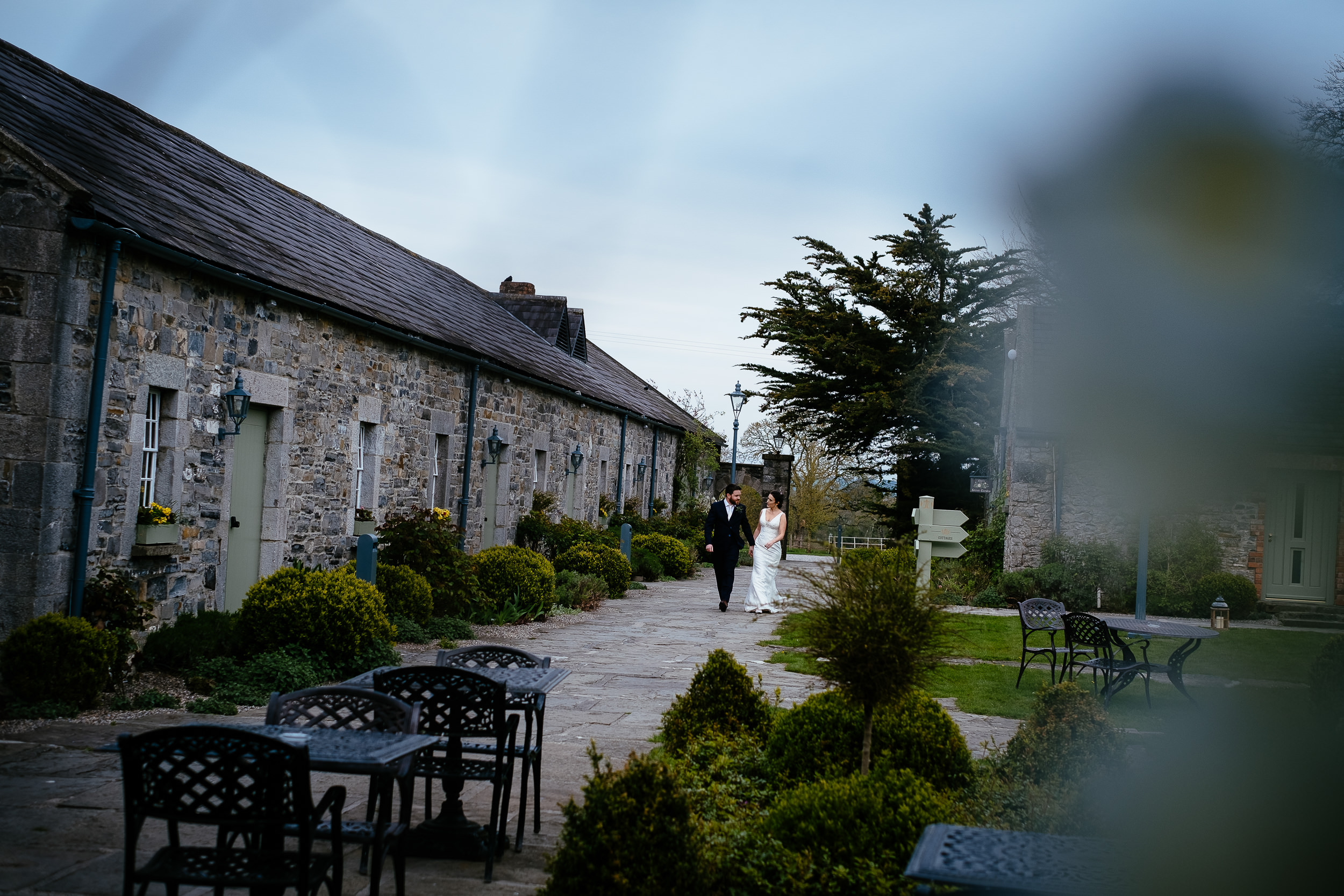 bride and groom walking through courtyard
