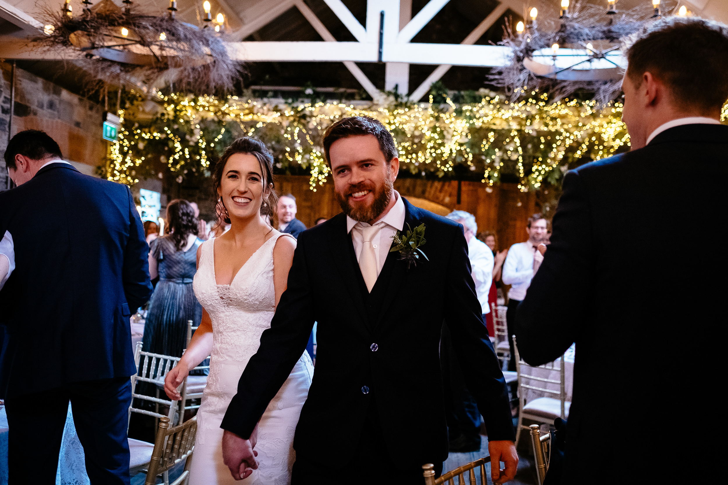 bride and groom entering the reception room for dinner laughing at Ballymagarvey village meath