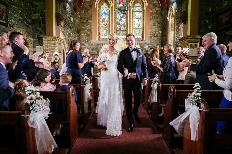 bride and groom walking down aisle after getting married in Culmullen Church before their Wedding in the Knightsbrook Hotel
