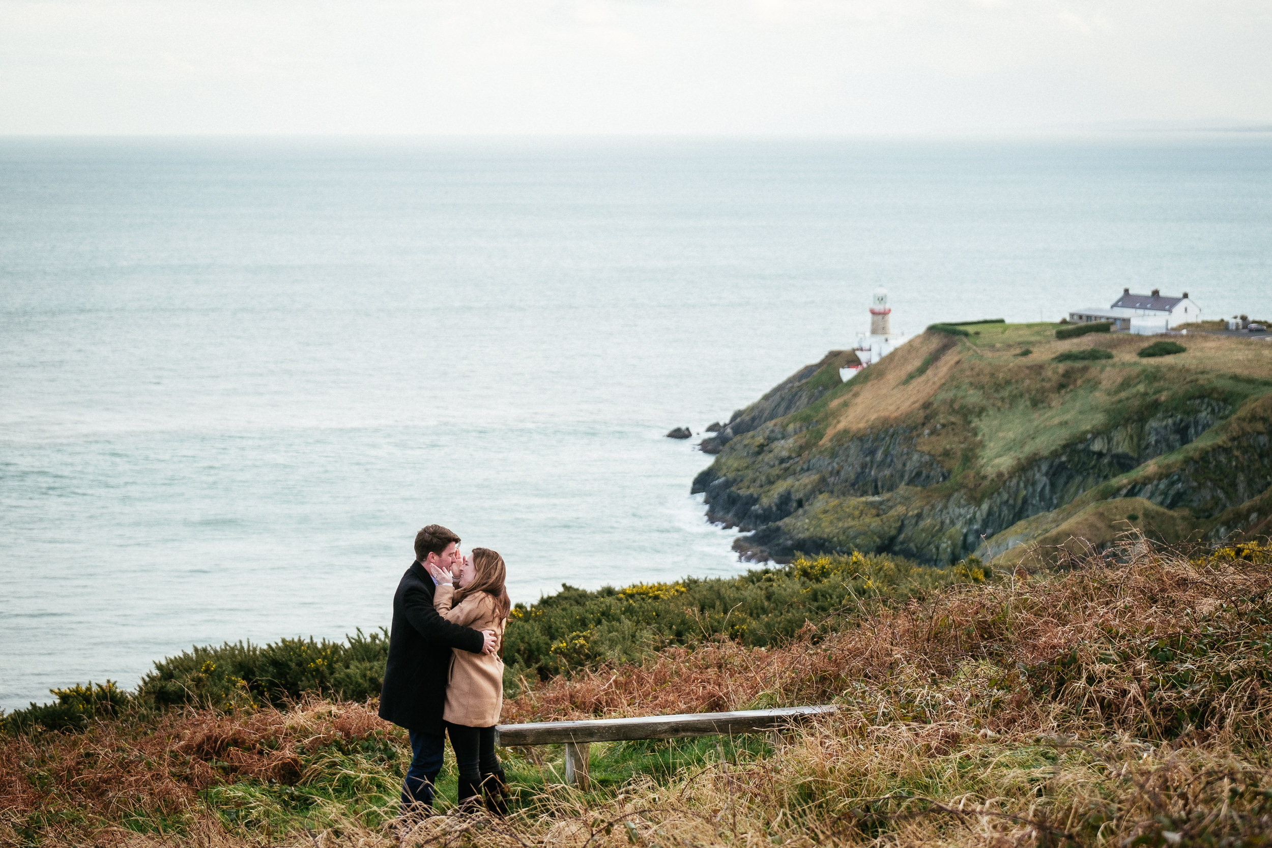 engaged couple kissing at howth summit