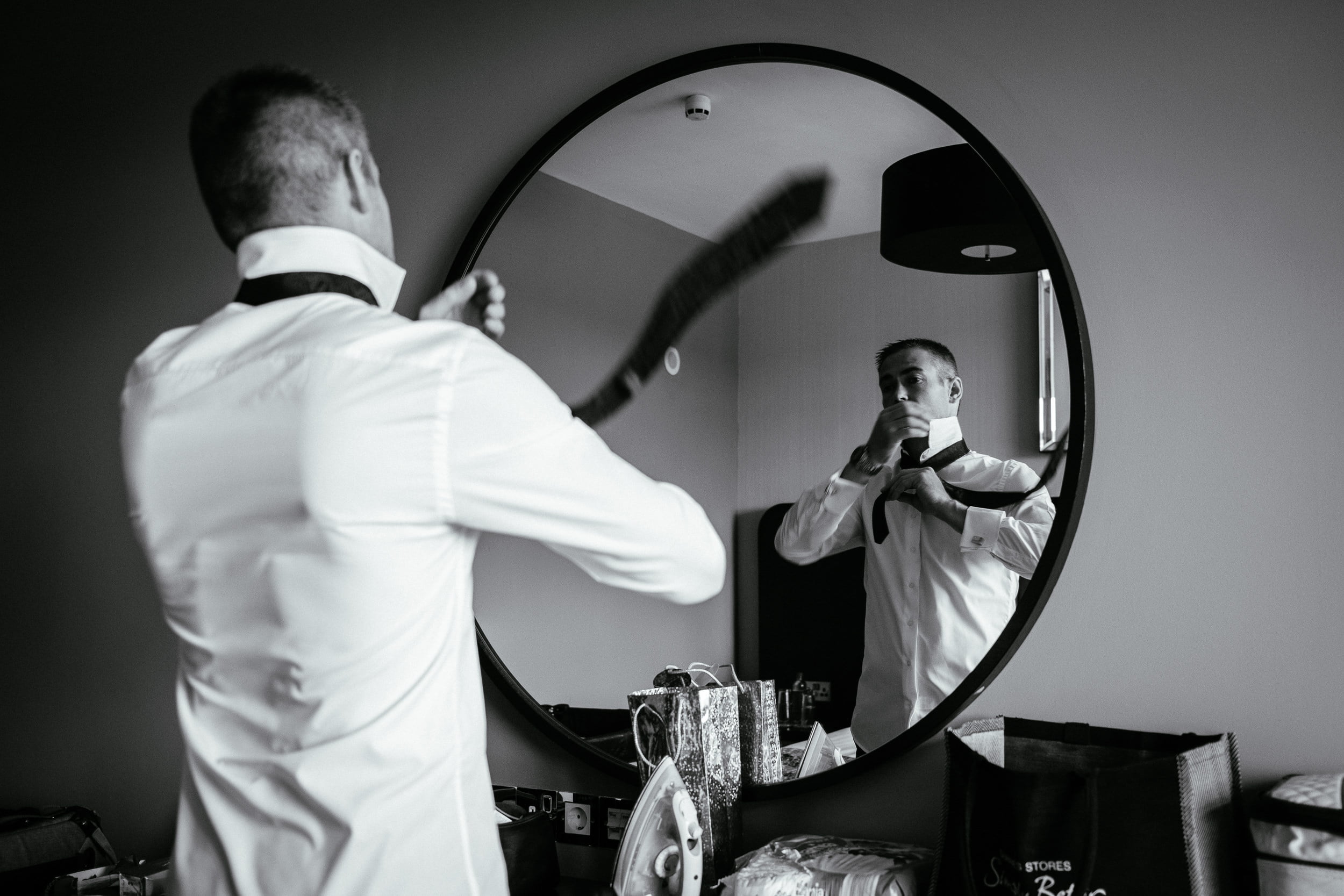 groom fixing tie at the Fota Island Resort Cork
