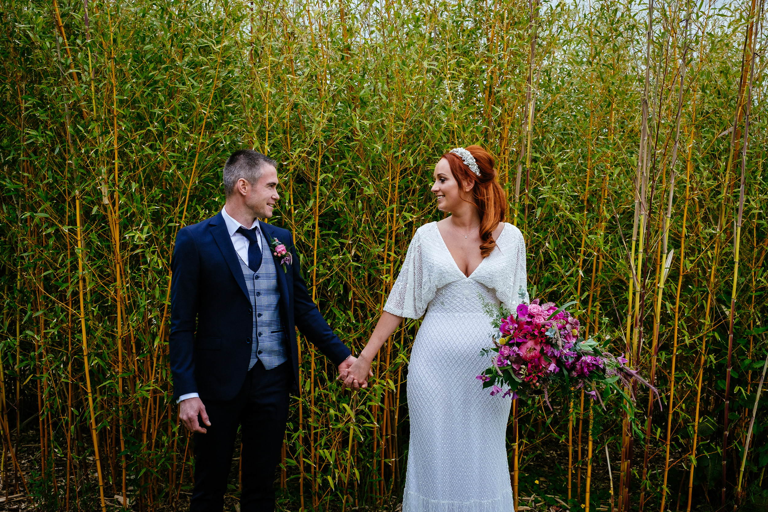 bride and groom standing in front of bamboo shoots at their intimate wedding in Fota Island Resort