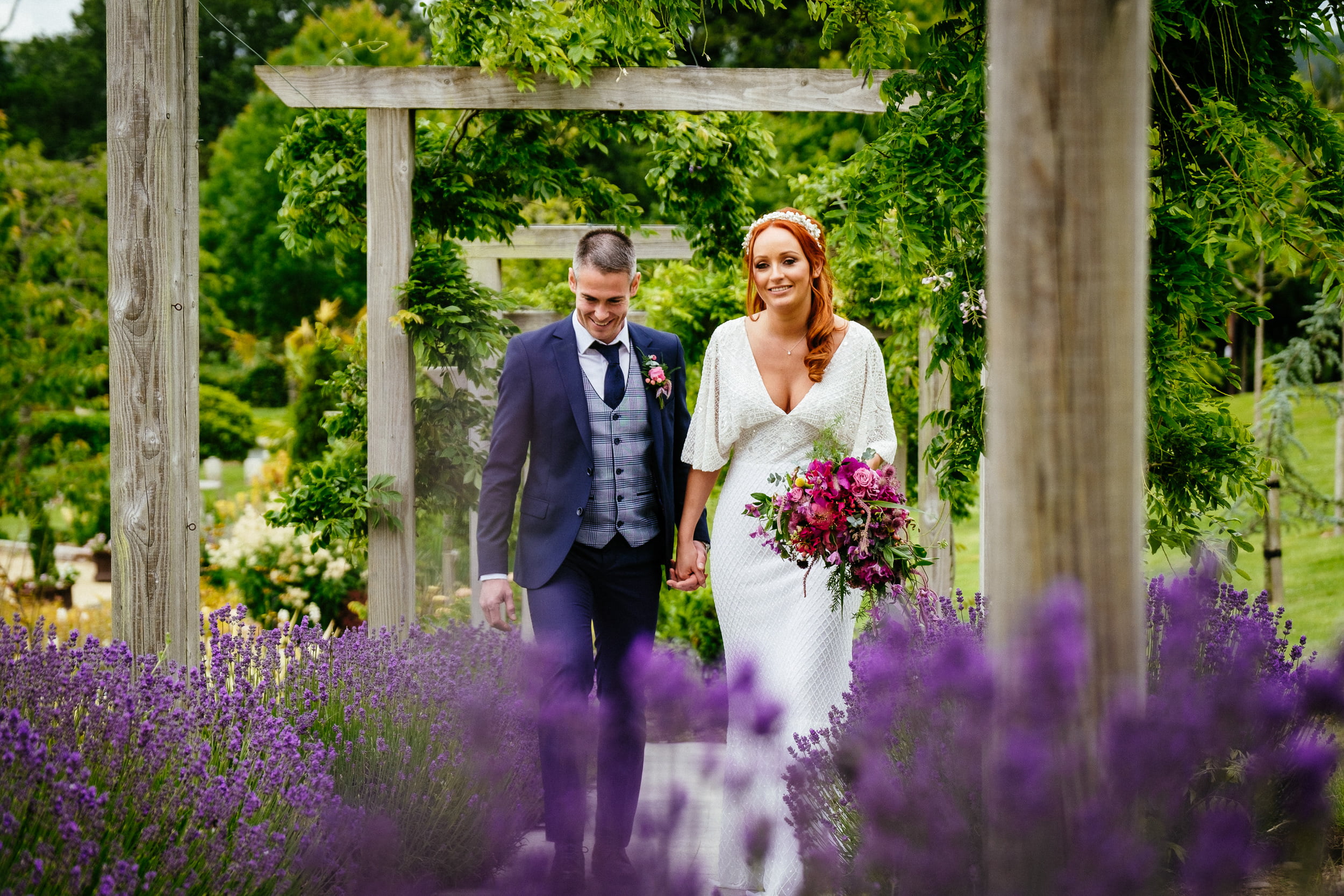 bride and groom walking through gardens at a Fota Island Resort Cork wedding