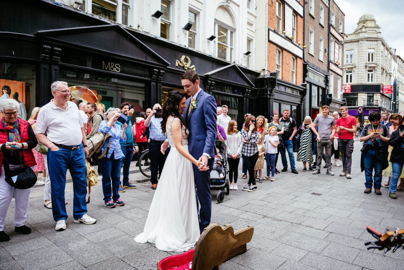 1 Beautiful Intimate Dublin City Wedding 96 bride and groom dancing on Grafton St Dublin surrounded by shoppers following their wedding