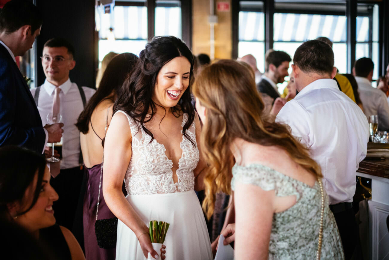 1 Beautiful Intimate Dublin City Wedding 112 bride laughing with wedding guests at pichet restaurant
