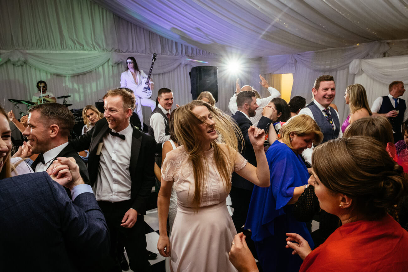 A group of people dancing at a wedding reception at Trump International Hotel Doonbeg.