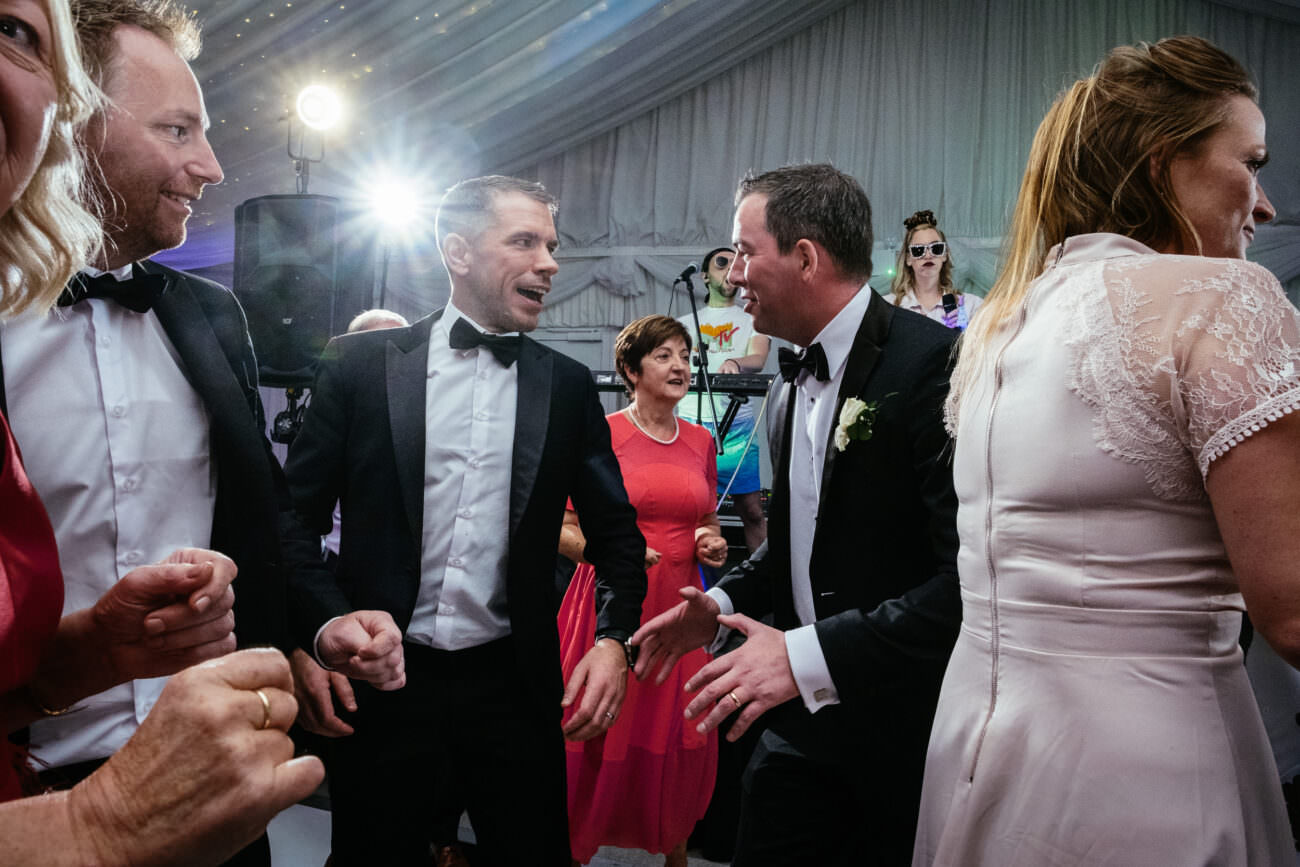 A group of people dancing at a wedding reception held at Trump International Hotel Doonbeg.