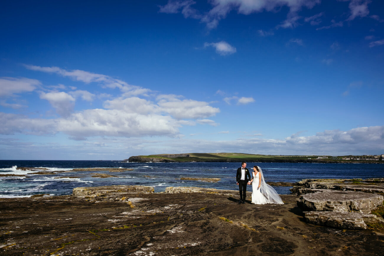 Bride and groom on the Kilkee cliff walk in high wind